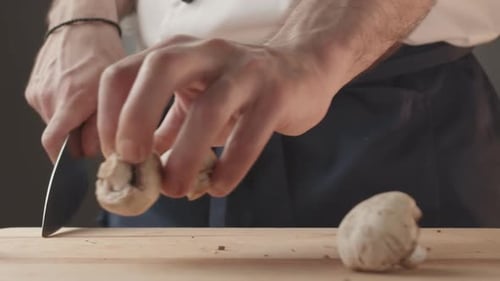 Chef Cuts Mushrooms on Cutting Board
