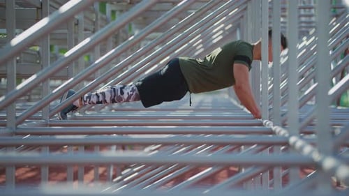 Man Performing Push-Ups on Metal Structure