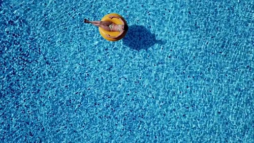 Top Scene To the Joyful Adult Girl Swim in Inflatable Ring Under Sunlight