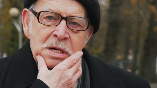 Close Up of Senior Man Talking in City