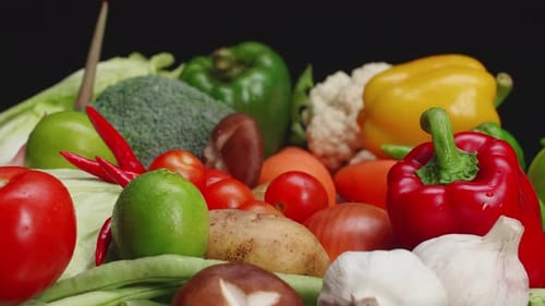 Fresh Vegetables and Fruits Against Dark Backdrop