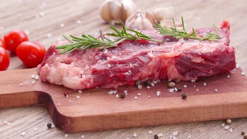 Fresh Raw Steak on Wooden Cutting Board