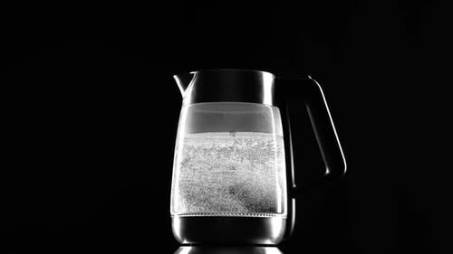 Water Boiling in Electric Kettle on Black Background