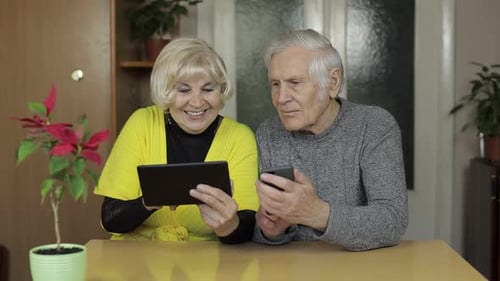 Seniors Enjoying Technology Together at Home