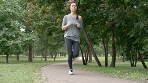 Young Woman Running in Park