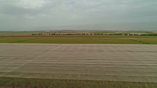 Aerial footage of net houses with banana plantations