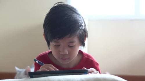 Child Uses Tablet with Stylus Pen
