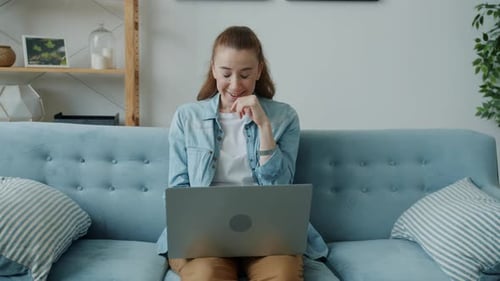 Excited Woman Celebrates Good News on Laptop