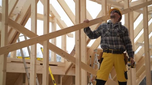 Construction Worker with Wooden Beam and Hard Hat