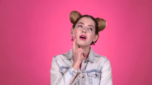 Young Woman Posing and Thinking on Pink Background