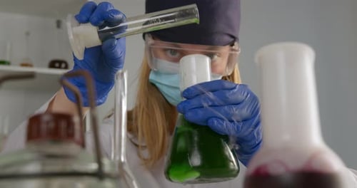 Woman Scientist Mixing Chemicals in a Laboratory Setting