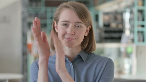 Blonde Woman Smiling and Clapping Her Hands