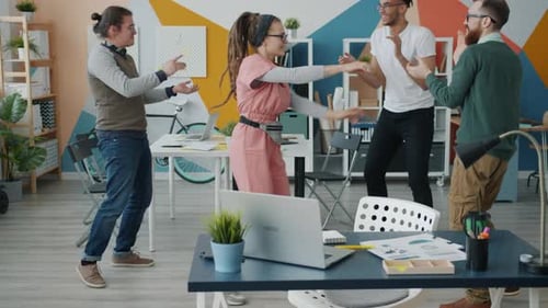 Slow Motion of Happy Girl with Dreadlocks Dancing in Office While Colleagues Having Fun Clapping