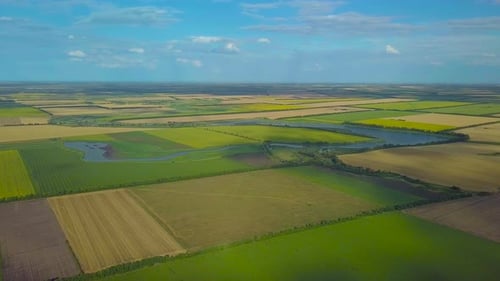 Aerial View of Vast Agricultural Fields and River