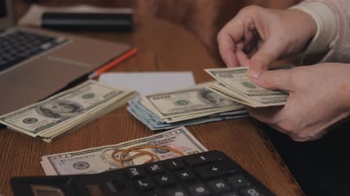 Counting money, old hands counting dollar bills