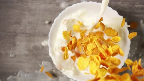 Corn Flakes Cereal with Milk Being Poured