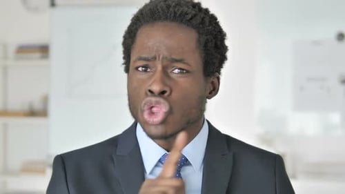 Upset Man Gesturing in Office Setting