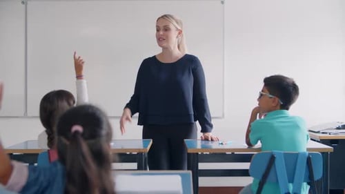 Enthusiastic Teacher Interacts With Eager Elementary School Students
