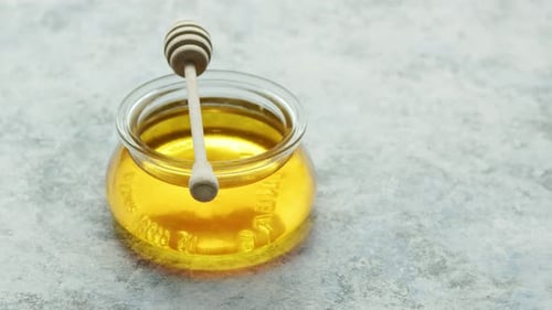 Glass Bowl of Honey on Table
