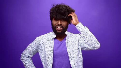 Young African American Man Thinking Purple Studio Background
