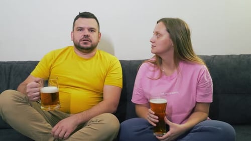 Couple Relaxing on Couch with Beer