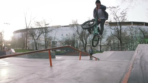 BMX Rider Doing Tricks in Street Plaza Bicycle Stunt Rider in Cocncrete Skatepark Super Slow Motion