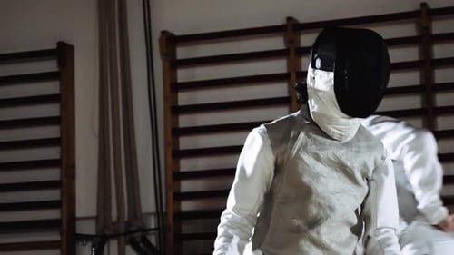 Man in Fencing Mask Parrying Opponent Running with Foil