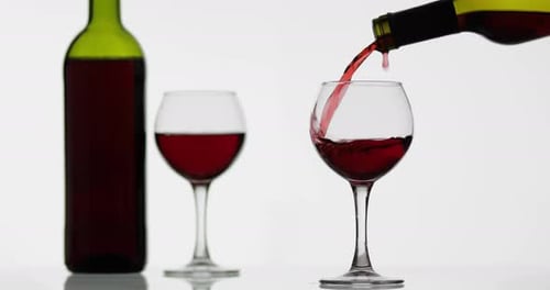 Rose Wine. Red Wine Pour in Wine Glass Over White Background