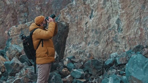 Man Exploring Wilderness Taking Photographs in Daytime