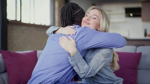 Loving Couple Embracing Affectionately on Couch