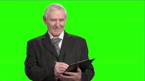 Senior Man Writing on Clipboard Green Screen