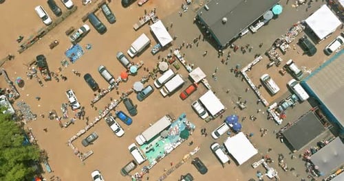 Panorama View on Flea Market Roof Top with Miscellaneous Items and Crowds of Buyers and Sellers in