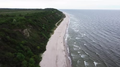 Aerial Footage of Curonian Spit in Kaliningrad and Tourists Walking on Beach at Bad Windy Weather