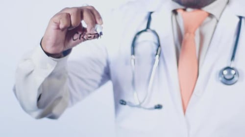 Doctor Writes on Transparent Surface in Clinic
