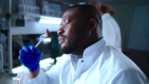 Scientist Tasting Food in a Laboratory Setting