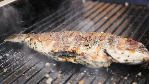Closeup Wonderful Fresh Fish Fried on Grill with Seasoning