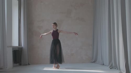 Graceful Ballerina Dancing Ballet in Bright Studio