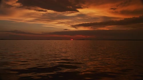 Setting Sun Over a River on a Colorful Sunset