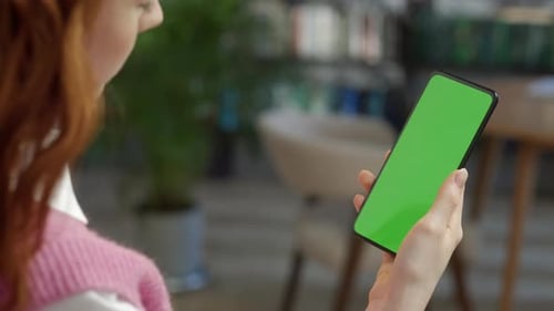 Back View of Woman at Phone with Green Screen for Copy Space