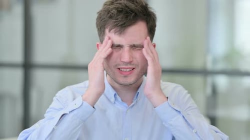 Young Man Experiencing Headache and Stress