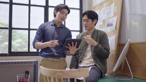 Collaborative Young Adults Reviewing Data on Tablet