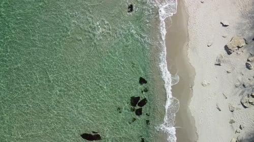 Aerial View of Rocky Beach and Sea Waves