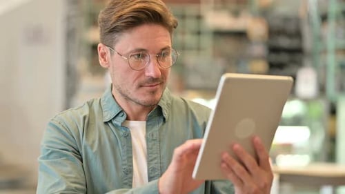 Man Using Tablet Device Indoors