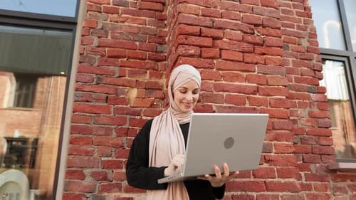 Happy Arabic Girl Standing Outdoor Near Work Office and Checking Email on Digital Gadget