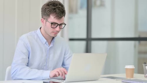 Young Adult Working on Laptop Says No