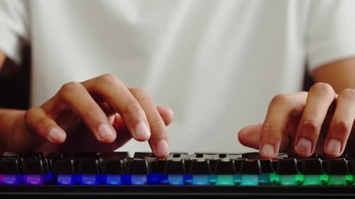 African American Man Gamer Using Backlight Keyboard Closeup Guy Playing Video Game