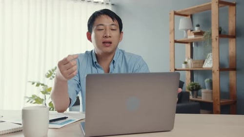 Young Adult Working Remotely at Home Office