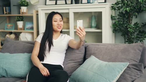 Woman Video Chatting on Phone in Living Room