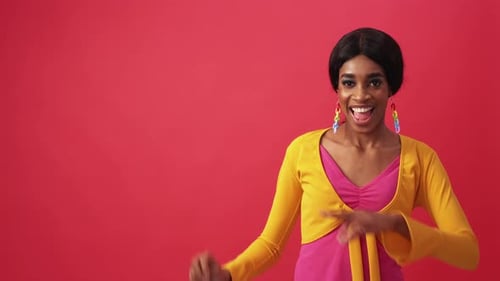 Woman Dances with Yellow Top on Red Background
