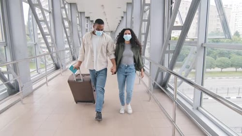Young Couple Holding Hands in Airport Terminal
